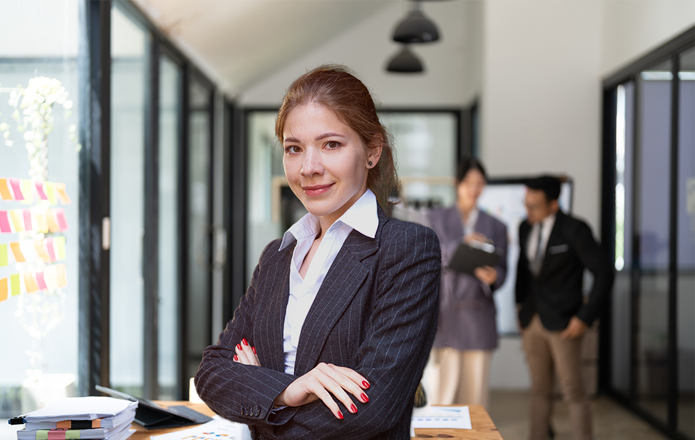 Female attorney in office with suit on looking at camera